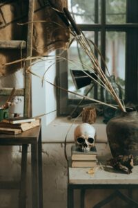 white and black skull figurine on brown wooden table